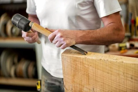 Carpenter or woodworker working with a chisel Stock Photos
