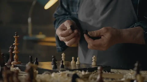 Carpenter, Owner of a medium-sized business Actively Holds chess piece in hi Stock Footage 241689428