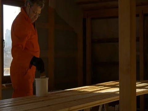 The carpenter painter processes the wood material for building. Video stock 73255878