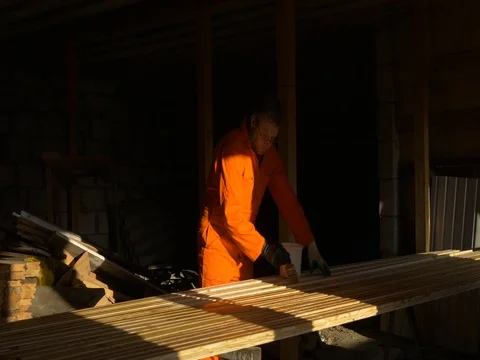 The carpenter painter processes the wood material for building. Stock Footage 73259330