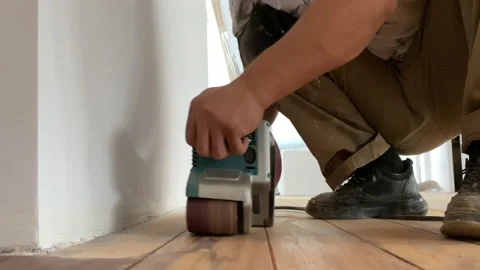 Carpenter performs repair work on grinding parquet floors..Sanding a wooden Stockbeeldmateriaal 159229510