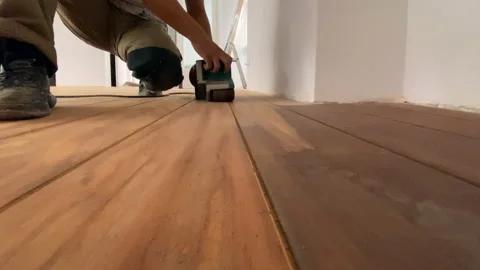 Carpenter performs repair work on grinding parquet floors Video stock 159239181