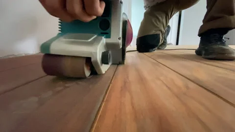 Carpenter performs repair work on grinding parquet floors Stock-Footage 159239374