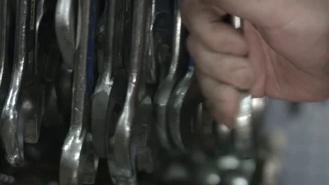 Carpenter picking up a wrench Stock Footage 69772212