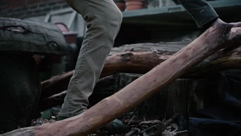 Carpenter picks up log to start carving wide slow motion Stock Footage 271195685
