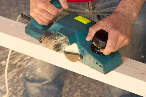 Carpenter with plane tool Stock Photos