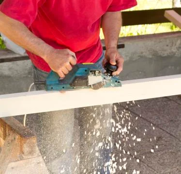 Carpenter with plane tool Stock Photos