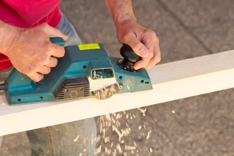 Carpenter with plane tool Stock Photos