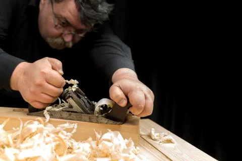 Carpenter planed board using planer Stock Photos