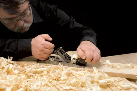 Carpenter planed board using planer Stock Photos