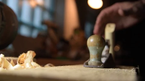 Carpenter with a planer at work in the workshop. Slow-motion close-up Video stock 128386689