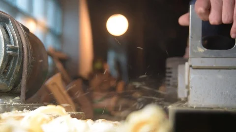 Carpenter with a planer at work in the workshop. Slow-motion close-up Video stock 128411262
