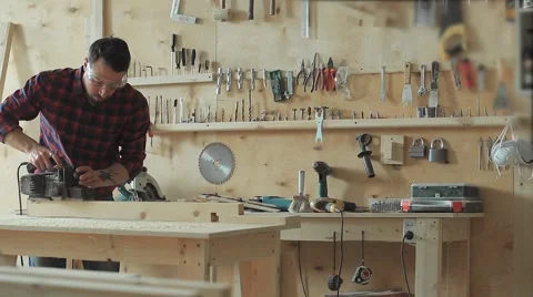 The carpenter planes the wood an electroplane Stock Footage 61815486