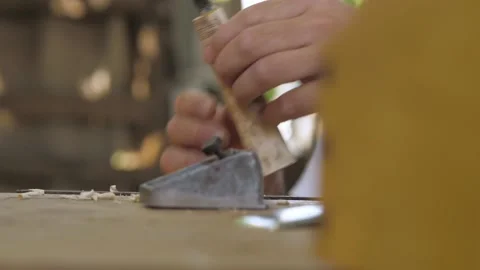 A carpenter planes a wooden handle for a chisel with a small plane. fhd. 24 f Stock Footage 137150077