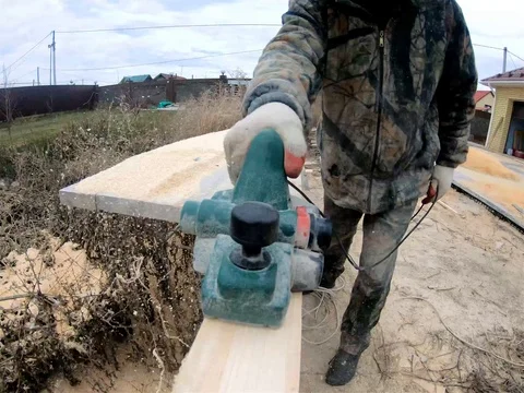 A carpenter planing board Stock Footage 98139917