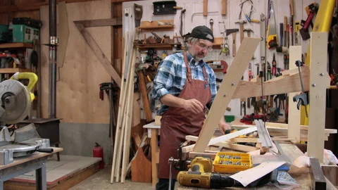 A carpenter is planing boards Stock Footage 323779584