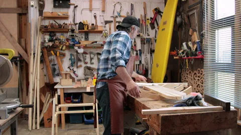 A carpenter is planing boards Stock Footage 323779630