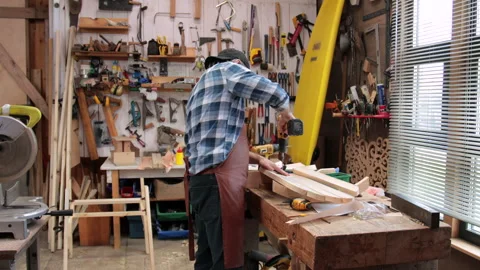 A carpenter is planing boards Stock Footage 323779678