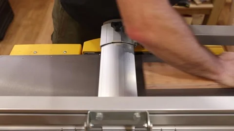 Carpenter planing wooden plank with surface planer in workshop 動画素材 311581453