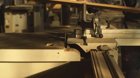 Carpenter with a plank on an electric saw machine Stock Footage 76277178