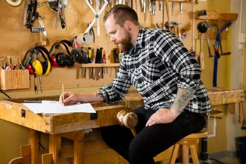 Carpenter planning new work in the workshop Stock Photos