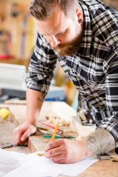 Carpenter plans work and notes at project drawings Stock Photos