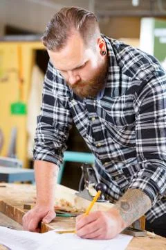 Carpenter plans work and notes at project drawings Stock Photos