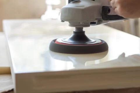 Carpenter polishes the surface of the facade before assembling furniture on a Stock Photos