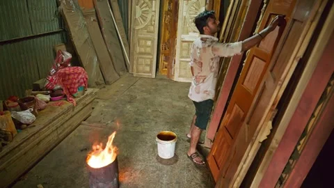 Carpenter polishes a timber panel in workshop Stock Footage 304851521