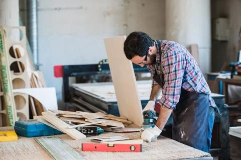 Carpenter with power grinder at his workshop Stock Photos