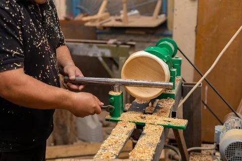 Carpenter preparing machine for turning wood on a lathe Stock Photos