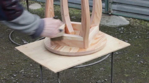 Carpenter is preparing stool for varnishing Stock Footage 63319048