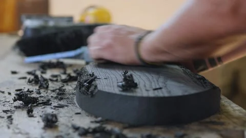 A carpenter processes bog oak with a small plane. woodworking and craftmanshi Stock Footage 144243479