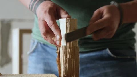 A carpenter processes a piece of wood with a file. art of woodworking Stock Footage 156683105