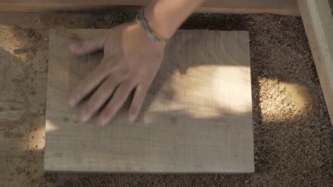 A carpenter processes a wooden board with a small plane Stock Footage 137149888
