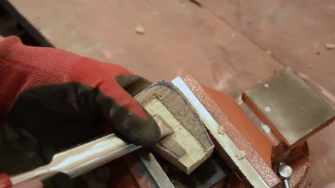 A carpenter processes a wooden part with a chisel. Stock Footage 156179704