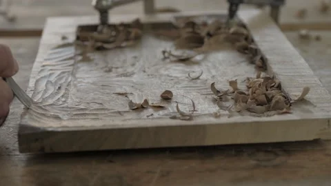 A carpenter processes a wooden plank with a chisel. handmade tea tray Stock Footage 137149663