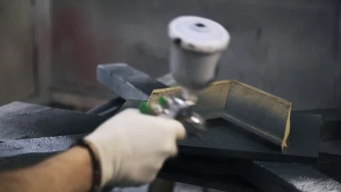 Carpenter is processing a sample of frame for canvas using black paint. Stock Footage 72256757