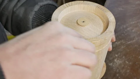 Carpenter is putting putty on the butt of wooden blank Stock Footage 150860034