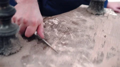 Carpenter removing old brown paint from wooden board surface with industrial Stock Footage 234982466