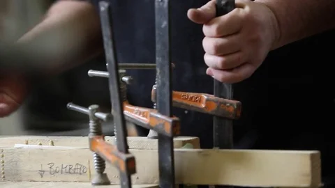 Carpenter removing vises. Luthier workshop. Stock Footage 74184109