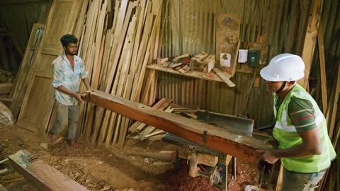 Carpenter in Rustic Workshop with Table Saw Stock Footage 295924492