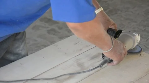 Carpenter s hands sanding plank using power Stock Footage 83792403