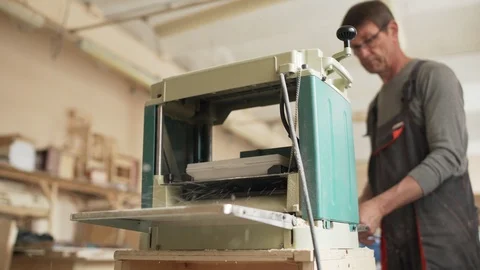 Carpenter sanding plank with woodworking machine Stock Footage 101800135