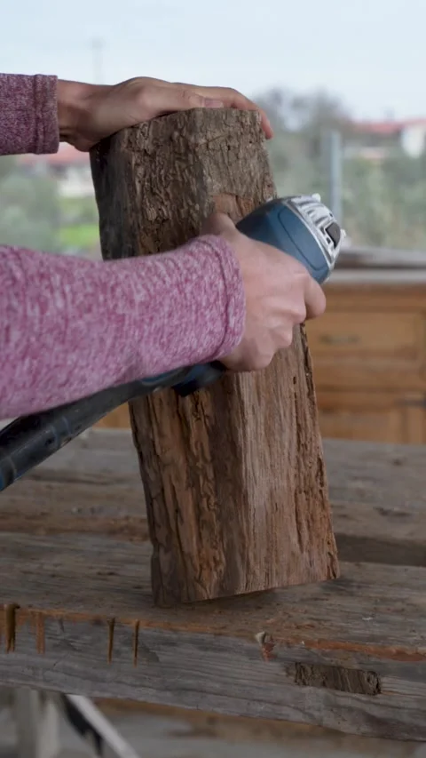 Carpenter sanding rustic wooden log with angle grinder Stock Footage 325202826