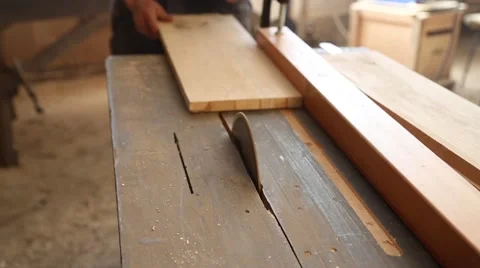 Carpenter sawing plank on a saw circulation Stock Footage 58742436