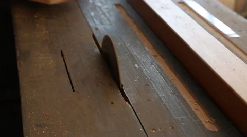 Carpenter sawing plank on a saw circulation Stock Footage 58742449