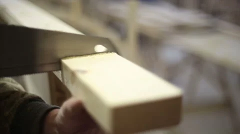 The carpenter saws off the block with a hacksaw Stock Footage 59520422