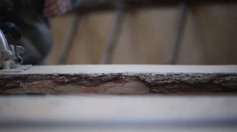 A carpenter saws off a board with a disk saw Stock Footage 59520250