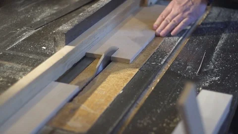 The carpenter saws the boards on a circular saw. Carpentry workshop Video stock 107611228